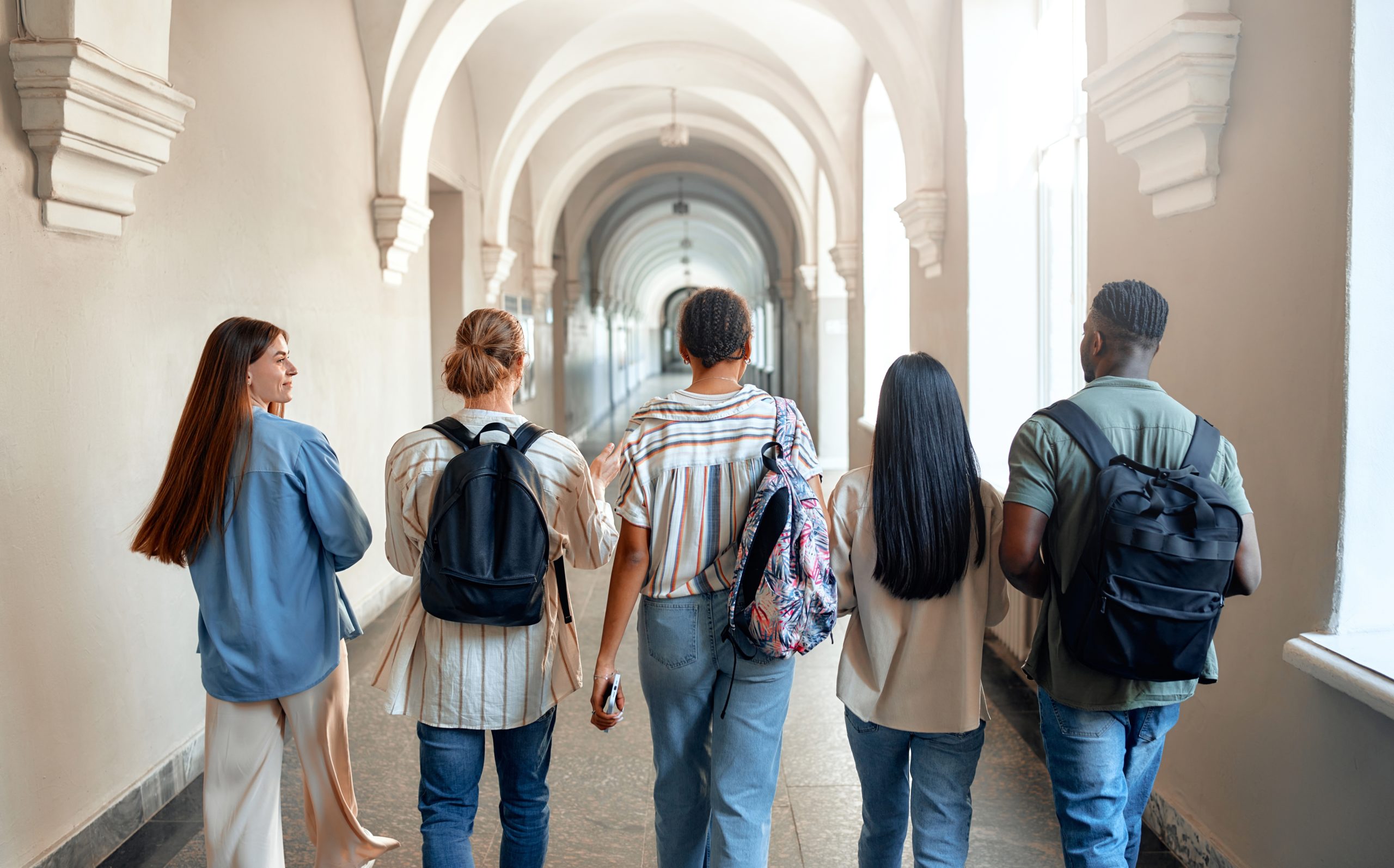 A,Diverse,Group,Of,Five,Students,Happily,Walk,Through,A
